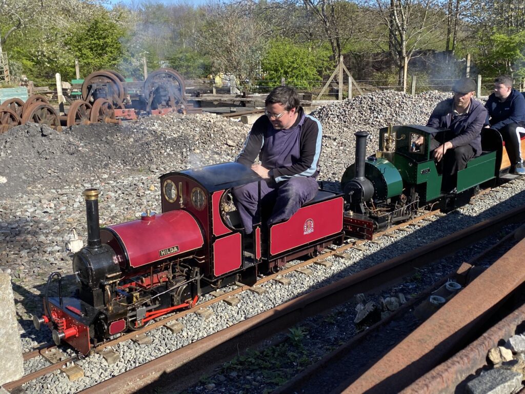 Hilda and Loki double head a miniature train.