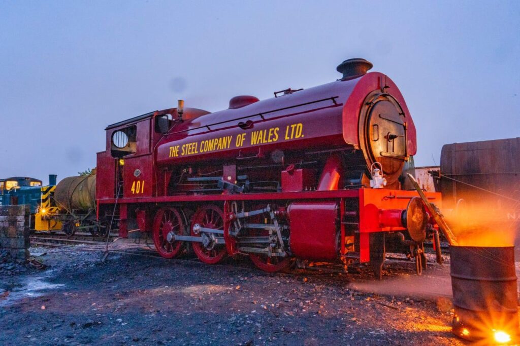 No. 401 behind a brazier on a dark evening